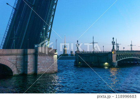 raised Liteyny Bridge in St. Petersburg on a white night, the Peter and Paul Cathedral is visible in the background raised Liteyny Bridge in St. Petersburg on a white night, the Peter and Paul Cathedral is visible in the background 118996683