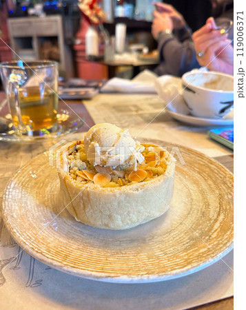 Delicious pastry topped with ice cream served in a cozy cafe, capturing the essence of delightful desserts and warm atmosphere on a casual afternoon. Sweet food Delicious pastry topped with ice cream served in a cozy cafe, capturing the essence of delightful desserts and warm atmosphere on a casual afternoon. Sweet food 119006371