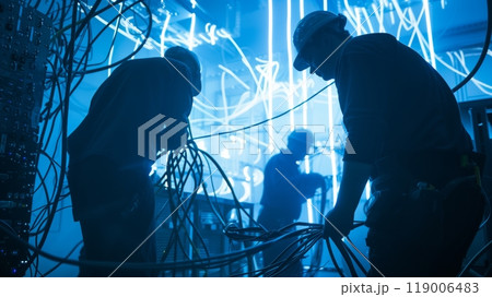 Electricians expertly navigate a maze of cables and equipment to wire a high-tech commercial building safely. Electricians expertly navigate a maze of cables and equipment to wire a high-tech commercial building safely. 119006483