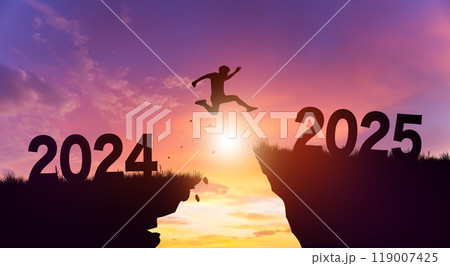 Welcome merry Christmas and Happy new year in 2025. Man jumping across the gap from 2024 to 2025 cliff with Sunset and Twilight Sky background. 119007425