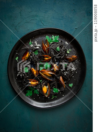Spaghetti with black squid, black pasta, with boiled mussels, on a black plate, with parsley and parmesan cheese, close-up, selective focus, no people, 119008058