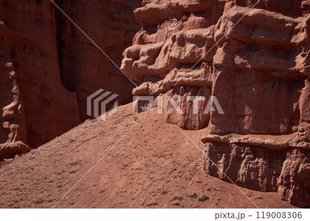 Rocky columns of red sandstone in canyon, aeolian deposits, result of soil erosion 119008306