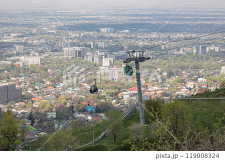 Cable car with two cabins, against the backdrop of the city. Aerial lift to Kok Tobe hill in Almaty, Kazakhstan 119008324