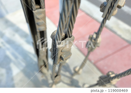 Close up steel turnbuckle and sling steel or Steel Wire Rope Sling and metal cable clamp connected with screw bolt in construction site. With selective focus. Close up steel turnbuckle and sling steel or Steel Wire Rope Sling and metal cable clamp connected with screw bolt in construction site. With selective focus. 119008469