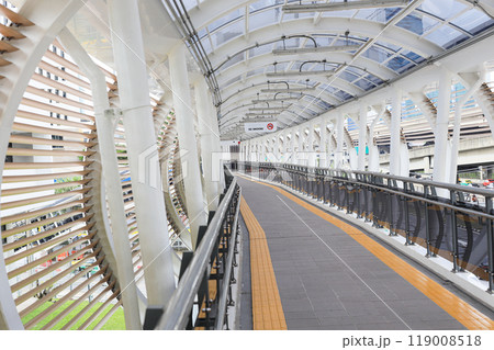 Pedestrian pathway or corridor or hallway between train station and other building. 119008518