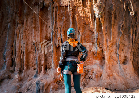 Girl is climbing on the red rocks, leads an active lifestyle. 119009425