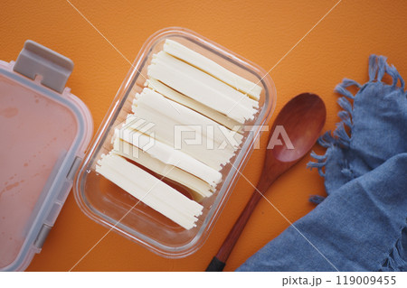Slicing cheese into pieces closeup,  119009455