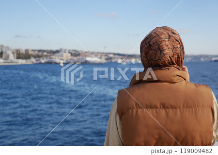 Unhappy girl standing at bench . 119009482