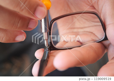 Repairing Eyeglasses A Detailed CloseUp of Skilled Hands at Work on Vintage Eyewear Pieces Repairing Eyeglasses A Detailed CloseUp of Skilled Hands at Work on Vintage Eyewear Pieces 119009519