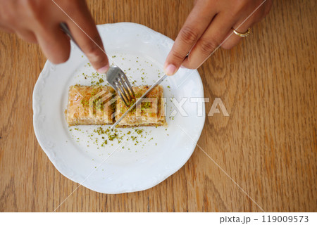 eating dessert baklava on a plate eating dessert baklava on a plate 119009573