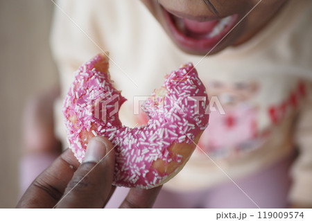 child mouth eating chocolate donuts child mouth eating chocolate donuts 119009574