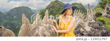BANNER, LONG FORMAT Woman tourist on background of amazing huge dragon statue at limestone mountain top near Hang Mua view point at foggy morning. Popular tourist attraction at Tam Coc, Ninh Binh 119012767