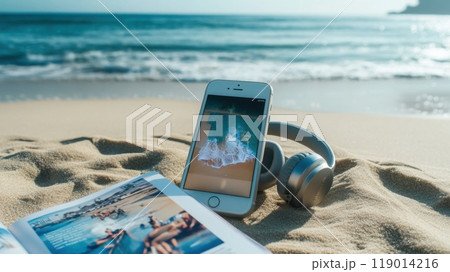 smartphone and earphones on the beach 119014216