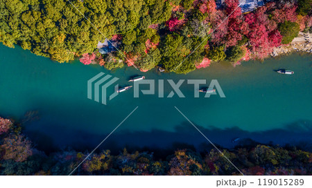 Arashiyama in autumn season along the river in Kyoto, Japan, Aerial view Arashiyama Togetsu or Togetsukyo bridge ancient architecture and boats in Katsura river, Arashiyama, Kyoto, Japan, Asia. 119015289