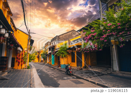 Streets with traditional ancient yellow houses in old town in Hoi An city in Vietnam in summer at sunset 119016115
