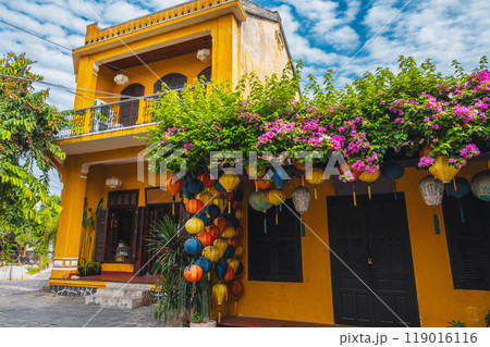 facade of an ancient Asian house decorated with colorful hanging Chinese lanterns for holiday in the old town in Hoi An in Vietnam 119016116