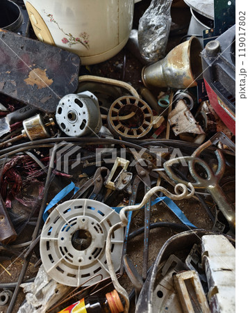 A pile of garbage with a bucket, rope, bottles, and other items at a landfill 119017802