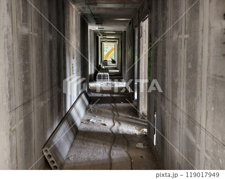 A long hallway featuring sturdy concrete walls and floor A long hallway featuring sturdy concrete walls and floor 119017949