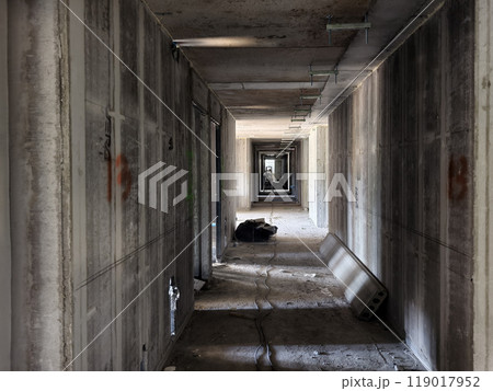 A long hallway featuring sturdy concrete walls and floor A long hallway featuring sturdy concrete walls and floor 119017952