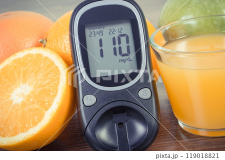 Glucose meter for checking sugar level, fresh fruits and orange juice 119018821