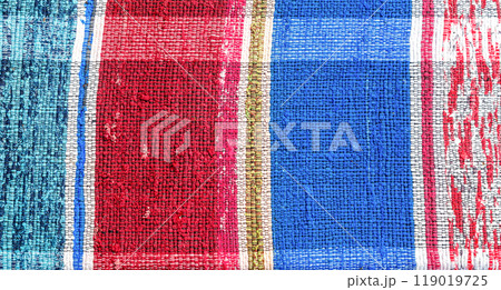 Old homespun doormat made from strips of cloth as background Old homespun doormat made from strips of cloth as background 119019725