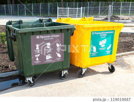 Separate trash containers on city street. Text in russian 119019887