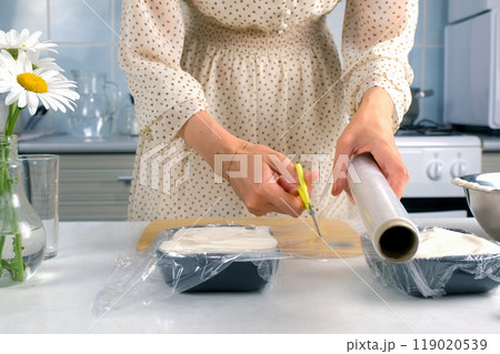 Woman cooking closing with file marshmallows mass to solidify in baking sheet. Woman cooking closing with file marshmallows mass to solidify in baking sheet. 119020539