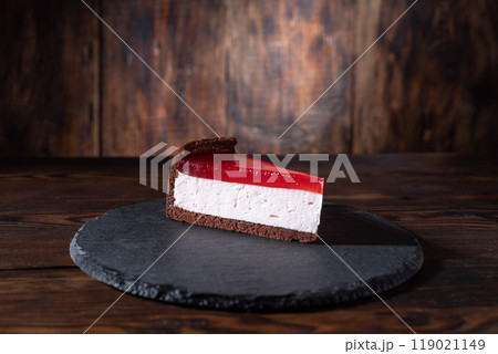 Cheesecake with red marmalade. Cake on a slate tray. A piece of cake with marmalade. Cheesecake with red marmalade. Cake on a slate tray. A piece of cake with marmalade. 119021149