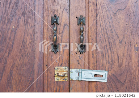 old steel lock with handles on wooden door old steel lock with handles on wooden door 119021642