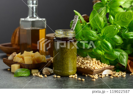 Pesto sauce and ingredients on a black stone table. Pesto sauce and ingredients on a black stone table. 119022587