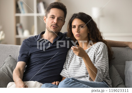 Serious attractive young husband and wife engaged in movie, series 119023311