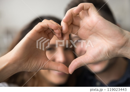 Hand heart shape with happy faces of young couple 119023443