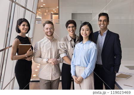 Successful diverse team of positive business colleagues standing in office 119023469