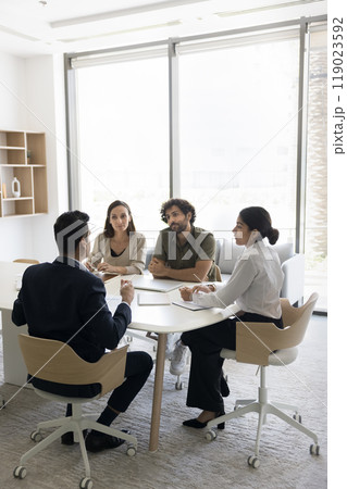 Diverse stakeholders team hold briefing discuss idea by conference table 119023592