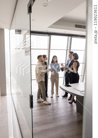 Multiethnic team of serious managers discussing teamwork in modern office 119023611