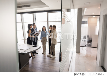 Diverse business group of colleagues standing in office meeting room 119023617