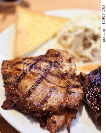 Close up chicken steak with salad, french fries and butter bread 119024762