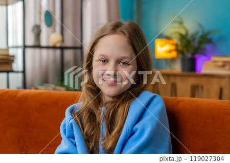 Portrait of happy smiling Caucasian preteen school girl child kid looking at camera, home play room Portrait of happy smiling Caucasian preteen school girl child kid looking at camera, home play room 119027304