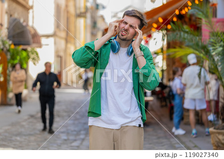 Displeased exhausted man rubbing temples to cure headache problem suffering from tension migraine 119027340