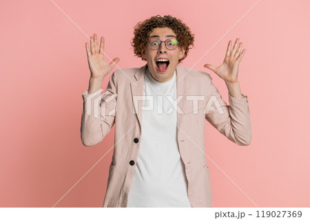 Excited amazed man surprise looking at camera with big eyes shocked by sudden victory wow emotion Excited amazed man surprise looking at camera with big eyes shocked by sudden victory wow emotion 119027369