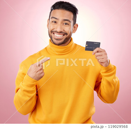 Man, pointing and credit card with finance, payment and loan, budget and fashion sale on studio pink background. Portrait, banking and happy asian person or gen z with retail transaction or shopping 119029568