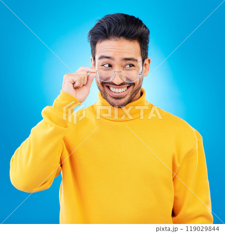 Thinking, glasses and Asian man with ideas, solution and happiness against a blue studio background. Male person, option and model with eyewear, opportunity or choice with a smile and problem solving 119029844