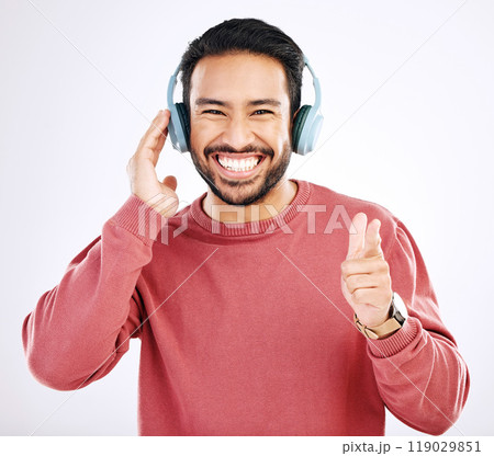 Headphones, smile and music, excited man in studio isolated on white background streaming radio and happiness. Podcast subscription, technology and song, Indian guy listening to audio online to relax 119029851