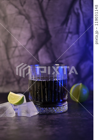 A Glass of Cold Sparkling Soda Water on Dark Background, Ice Cube and Lime Near a Glass A Glass of Cold Sparkling Soda Water on Dark Background, Ice Cube and Lime Near a Glass 119031148