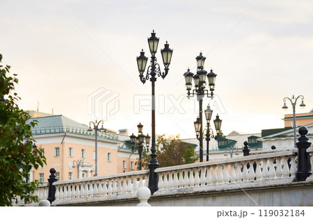 Beautiful white marble balusters and lamp posts on Manezhnaya Square in Moscow. Cityscape. Beautiful white marble balusters and lamp posts on Manezhnaya Square in Moscow. Cityscape. 119032184