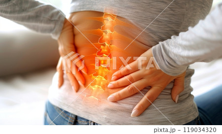 Close-up of young woman experiencing severe lower back pain, spinal pain relief concept. 119034320