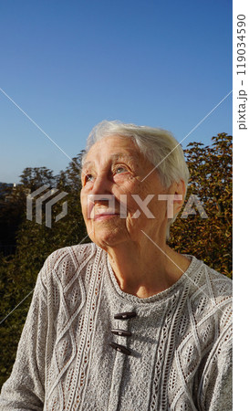 Portrait of sad senior woman posing in autumn park Portrait of sad senior woman posing in autumn park 119034590
