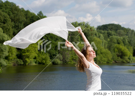 Young woman with white cloth, concept of ease and freedom Young woman with white cloth, concept of ease and freedom 119035522