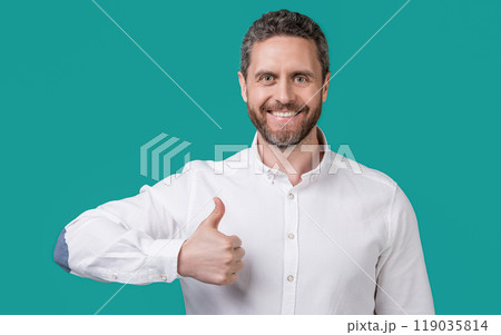 photo of mature businessman with stubble show thumb up. mature businessman isolated on blue 119035814