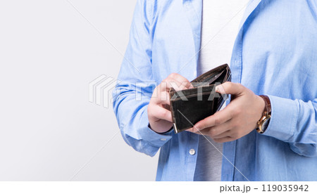 closeup of broke man with wallet isolated on studio background. broke man with wallet 119035942